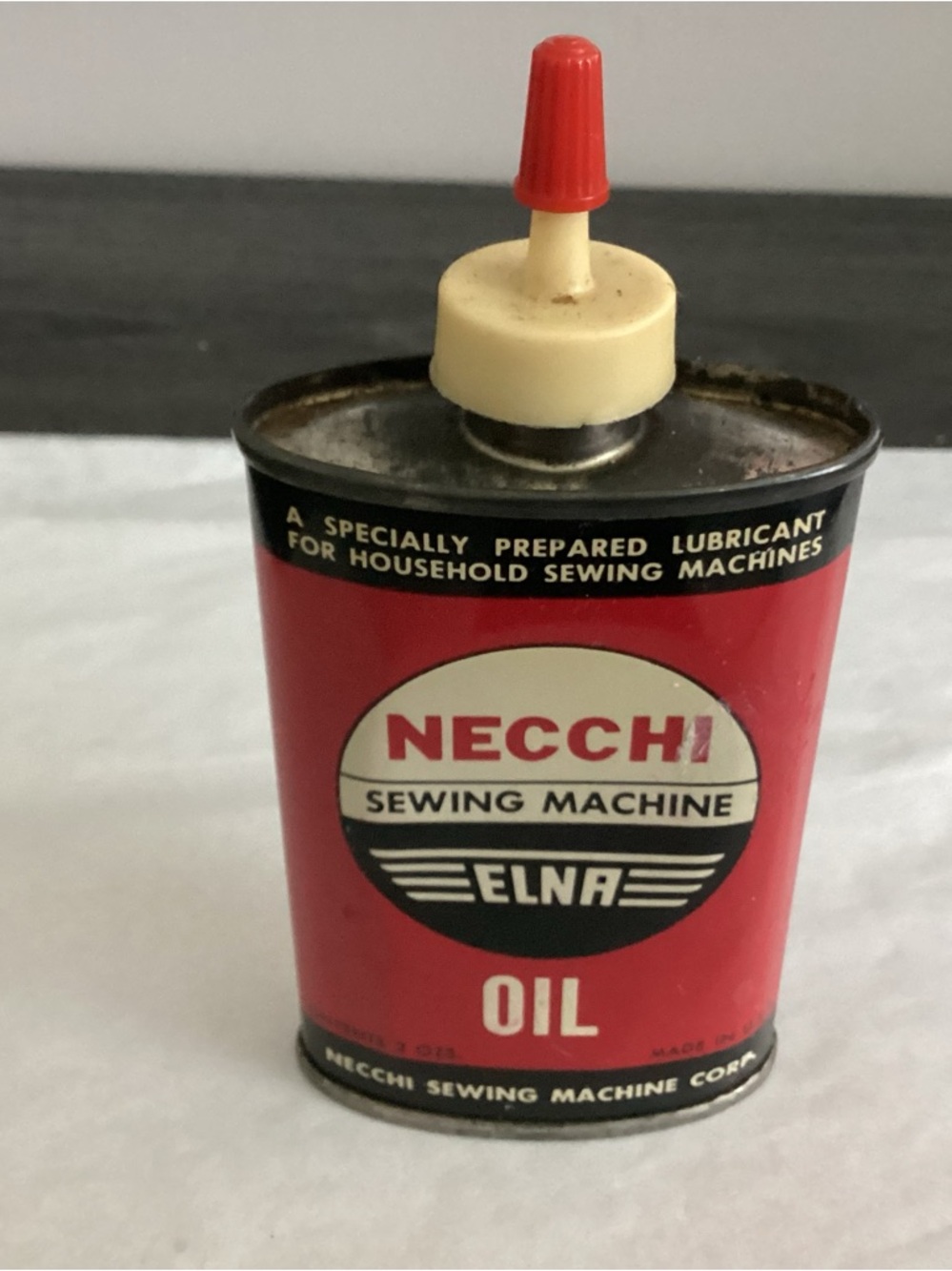 Vtg. Necchi sewing machine oil 3 oz. Tin red/black white tin graphics.